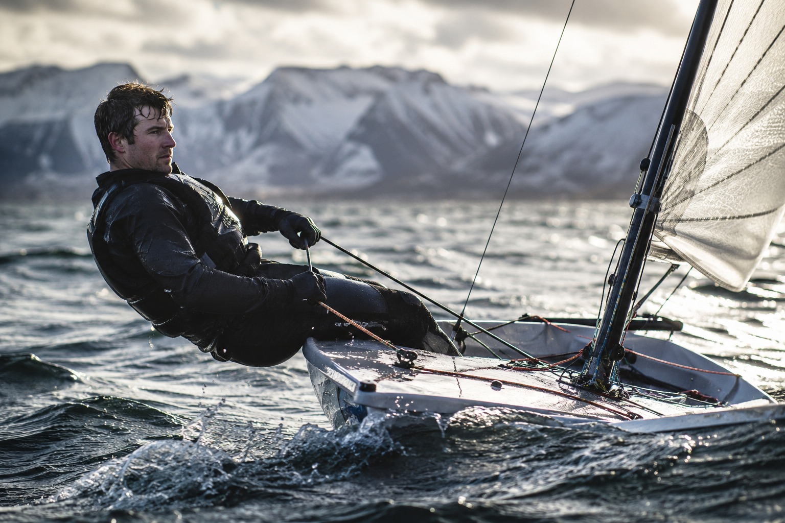 Sailor training hard in cold winter conditions in a dinghy